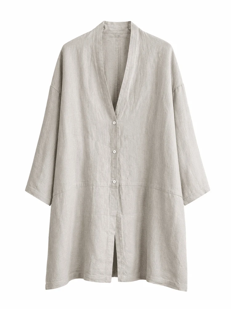 A neutral linen layering coat photographed against a light background